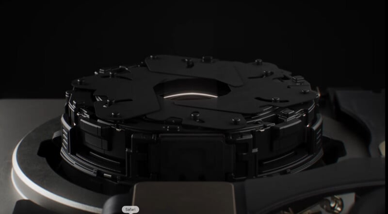 A close-up view of a mechanical camera aperture mechanism with overlapping black blades surrounding a central lens opening.