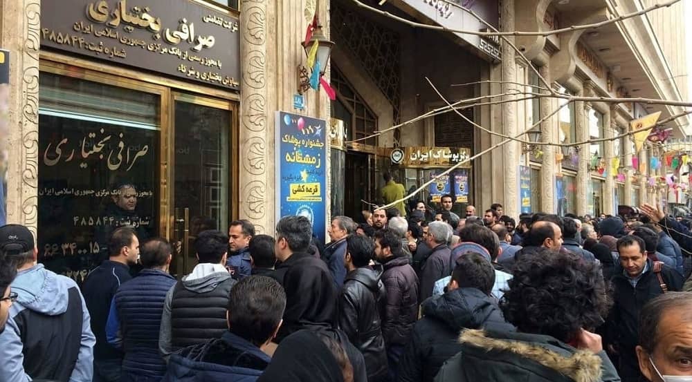 Crowds gather outside a currency exchange office in Tehran amid economic uncertainty and currency devaluation