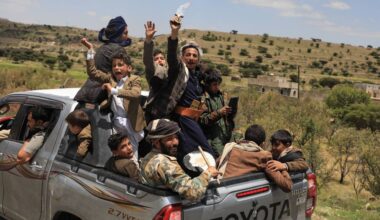 Yemeni civilians celebrate while riding in the back of a pickup truck in the Bani Matar district, Yemen, Saturday, Sept. 12, 2026, as they follow a convoy carrying Houthi prisoners freed in Mokha on its way to Sanaa following the Houthi takeover of the southern Red Sea port city. (AP Photo/STR)