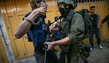 Israeli forces block journalist and activist Andrey X (L) as they set up iron barriers during a raid in the Old City of Hebron, West Bank, Palestine on August 29, 2026. (AA Photo)