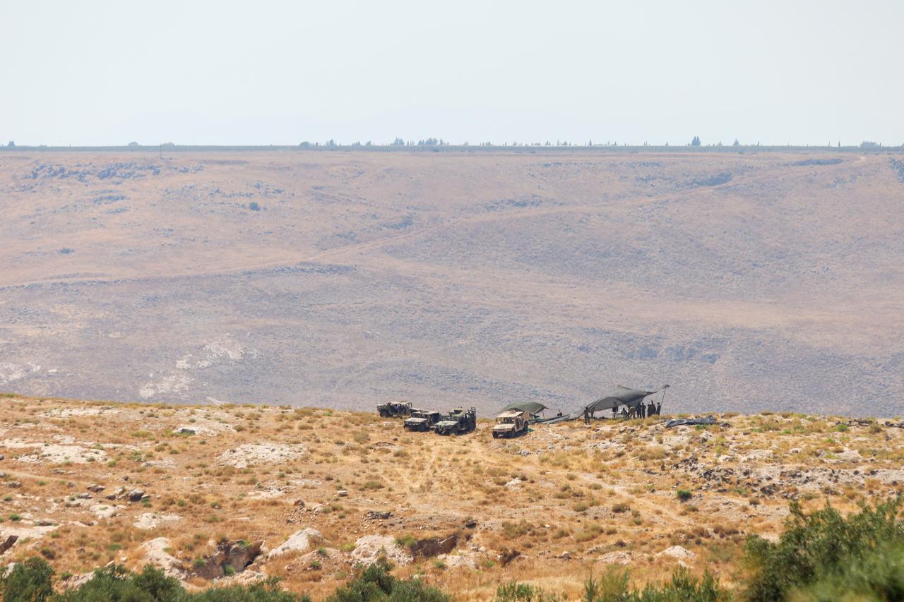 Elements of the Israeli military camp with armored vehicles along the strategic connecting road between the villages of Jamla and Saysoun in the western countryside of the Daraa Governorate in southern Syria on June 28, 2026. (AA Photo)