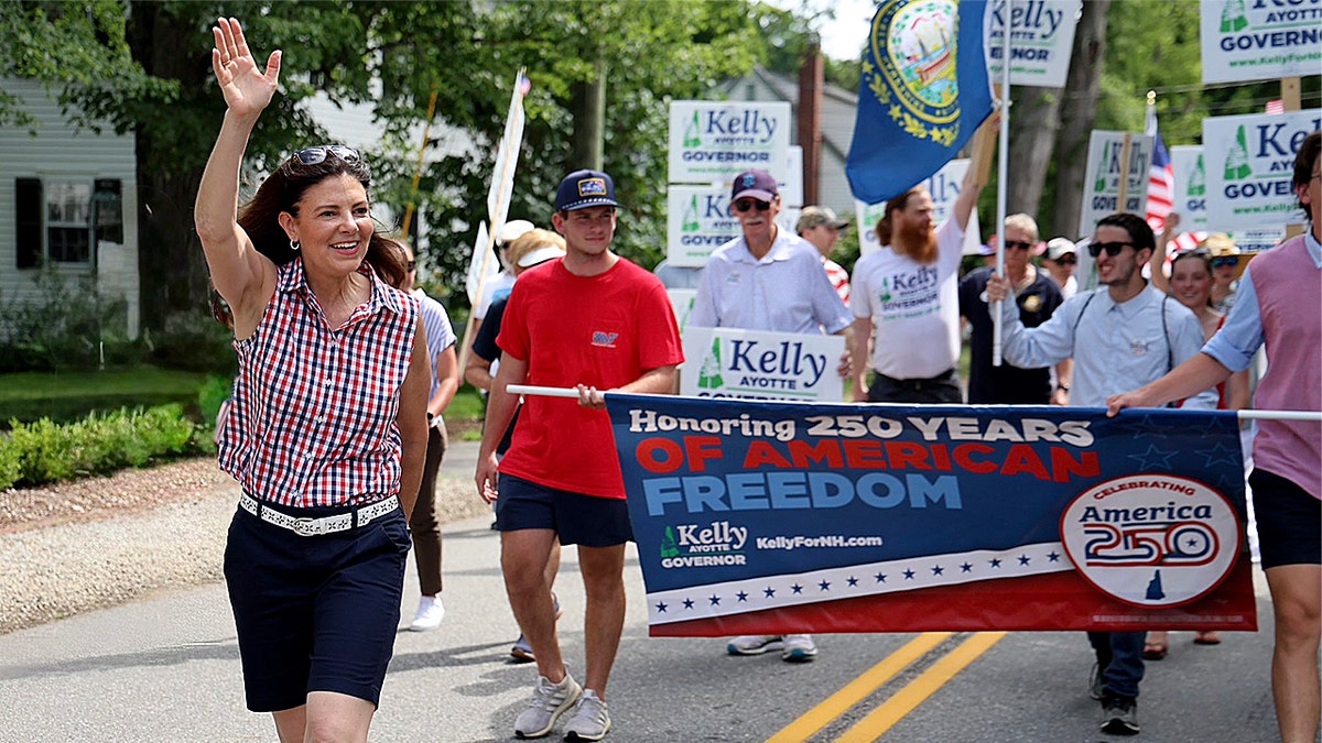 New Hampshire Gov. Kelly Ayotte marches in July 4th parade