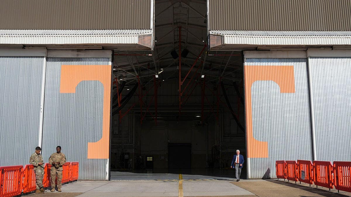 Media waits in a hangar at McGhee Tyson Air National Guard Base in Alcoa, Tenn.