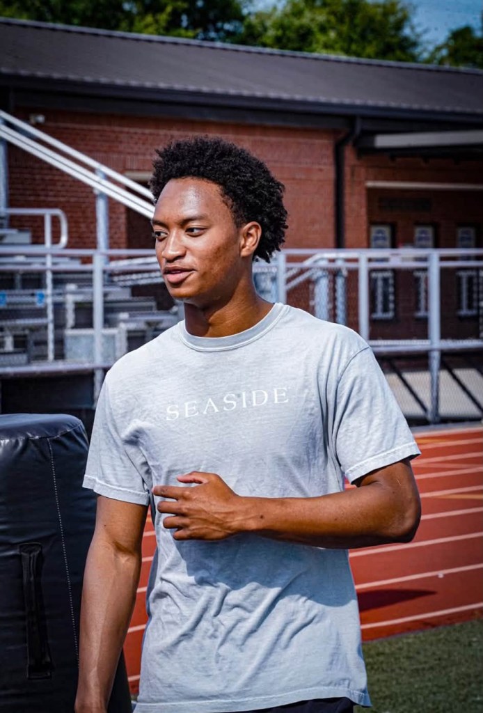 Photo of Nolan Wells, an 18-year-old missing in Mississippi, wearing a light blue t-shirt with "SEASIDE" written on it.