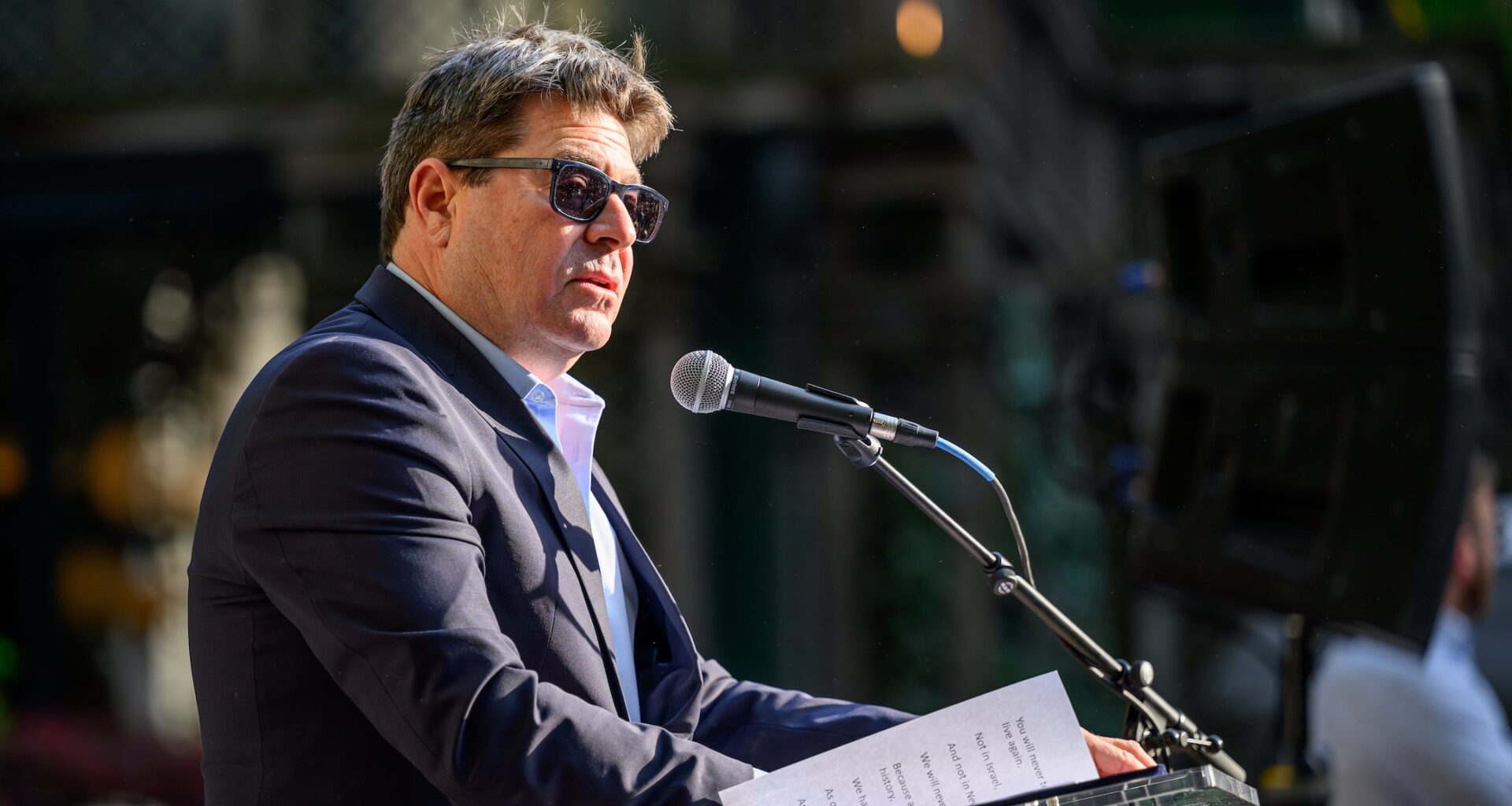 A photo of ofir akunis speaking into a mic.