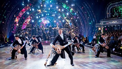 The Strictly professionals dance in the ballroom, the male pros dipping the female pros.