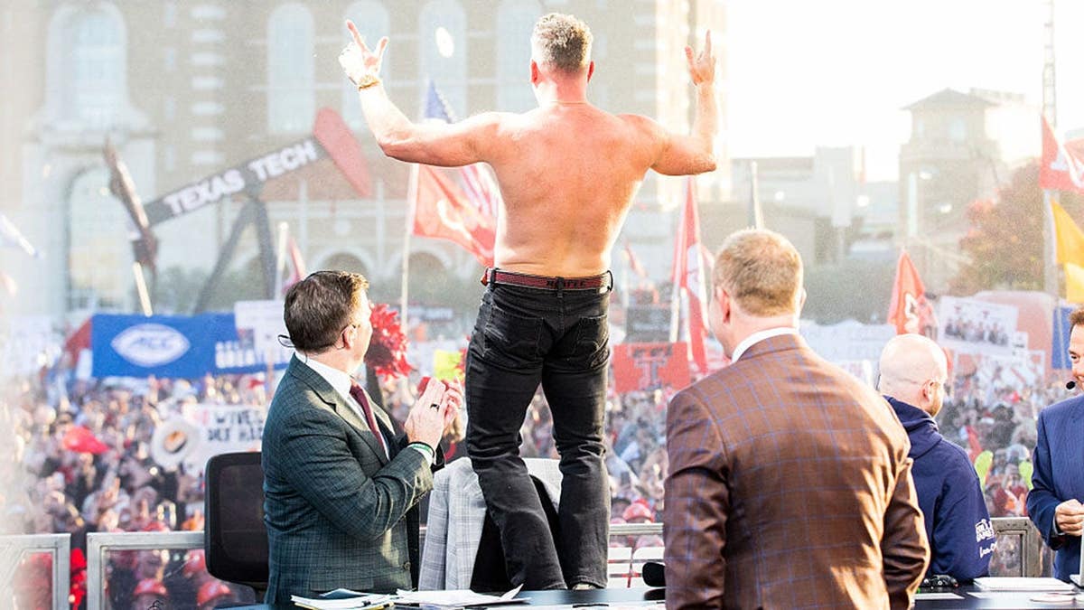Pat McAfee gestures Guns Up at Texas Tech University.