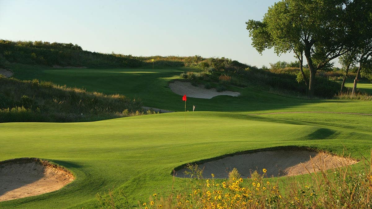 Golf green on the 3rd hole with the 4th hole visible behind at Prairie Dunes Country Club.