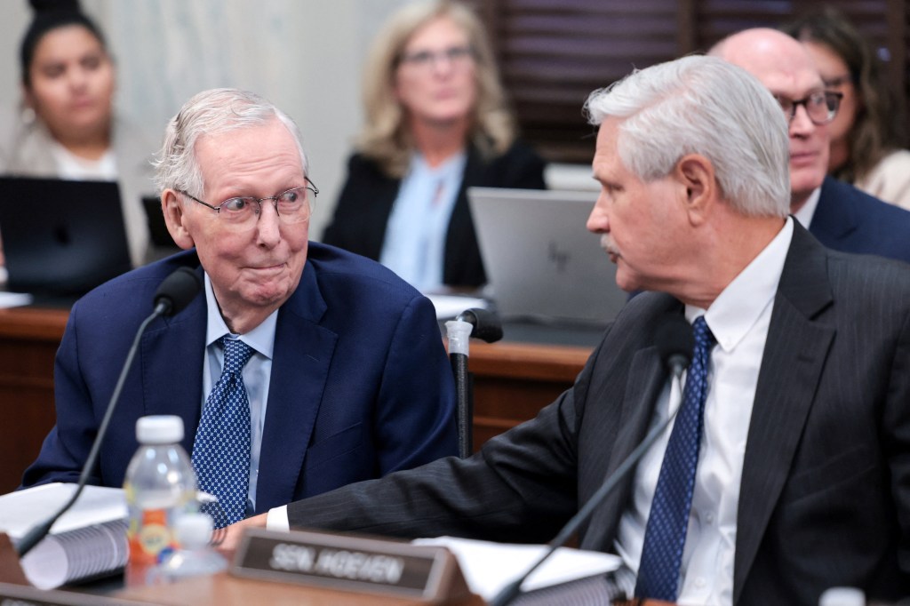 Senator Mitch McConnell, R-Ky., talking to Senator John Hoeven, R-N.D., at a Senate Agriculture Committee meeting on Capitol Hill.