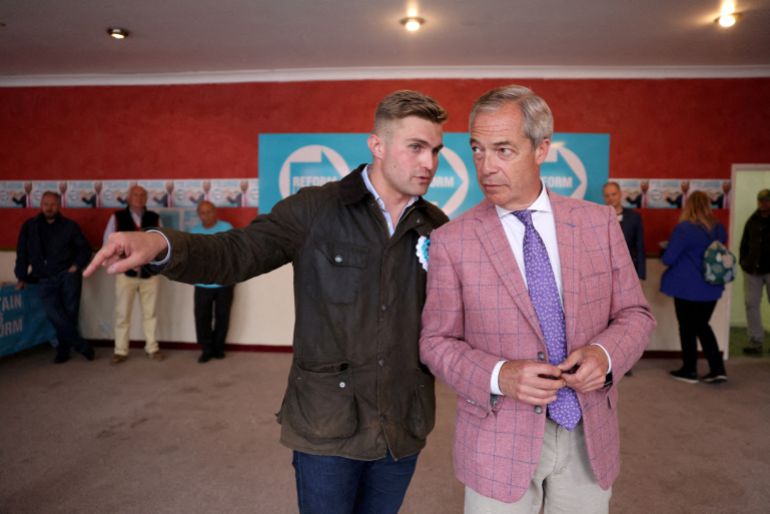 FILE PHOTO: Advisor Dan Jukes speaks to UK Reform party leader Nigel Farage before an interview ahead of Thursday's general election in Clacton-on-Sea, Britain, July 2, 2024. REUTERS/Hollie Adams/File Photo TPX IMAGES OF THE DAY