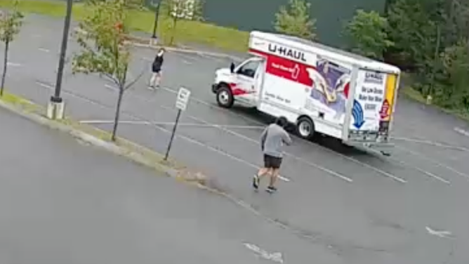 The man and the bystander scared the animal away from the U-Haul. 