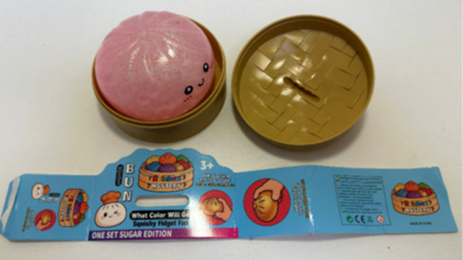 Recalled Rainbow Mystery Squishy Bun, tan container and packaging