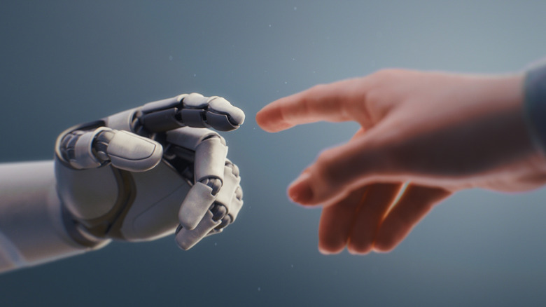 Robotic arm reaching out to a human hand.