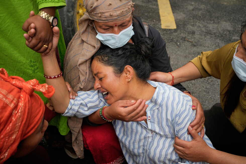 Photos show a family in Nepal bid farewell, as other flood victims are buried in unmarked graves