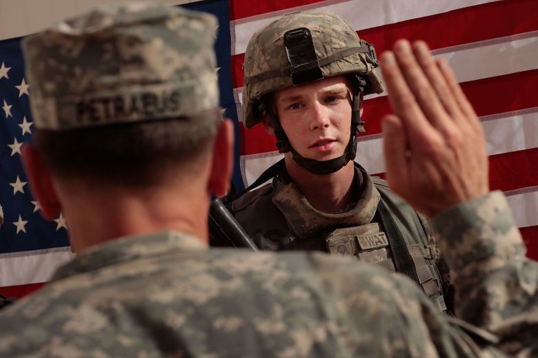 Spc. Christopher Watson is sworn in by Gen. David Petraeus for re-enlistment at Forward Operating Base Warhorse in Bacouba, Iraq, in July 2007.