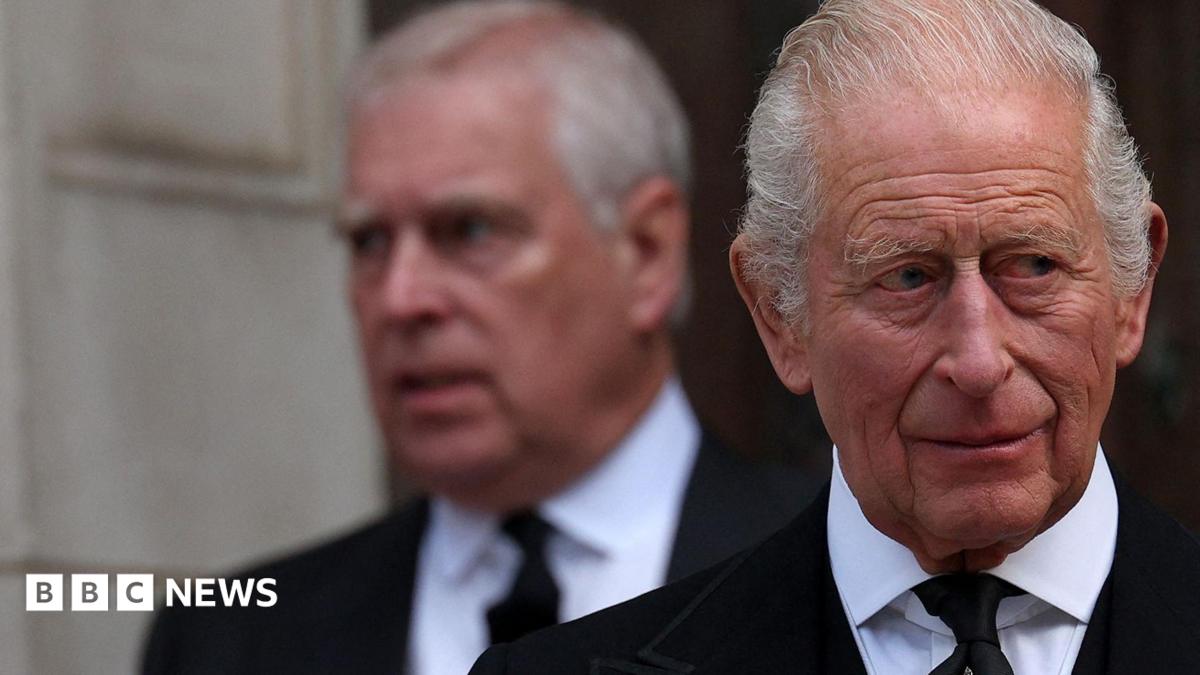 King Charles in the foreground of the image looks away to the left of the frame, whilst his younger brother Andrew Mountbatten Windsor is seen behind him, slightly out of focus.