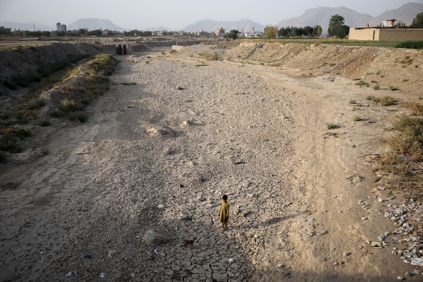 A boy stands on the dried-up Kabul river bed, amid a serious water crisis in Kabul, Afghanistan, August 29, 2025.