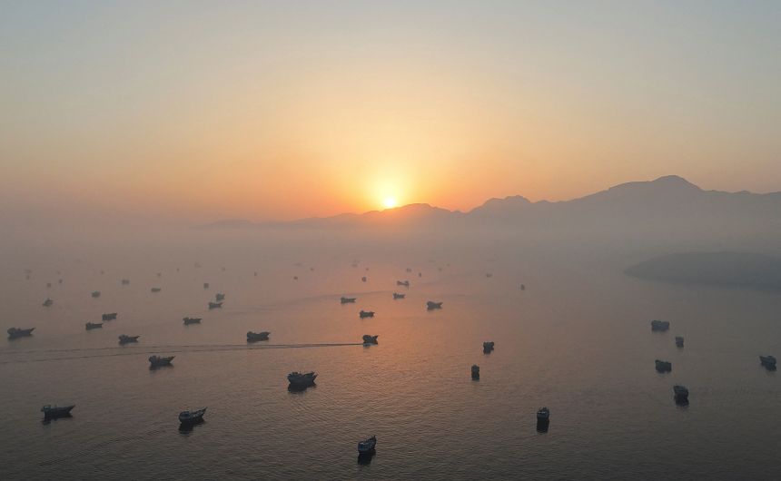 Vessels sit on the Strait of Hormuz on June 15, as seen from Musandam, Oman.