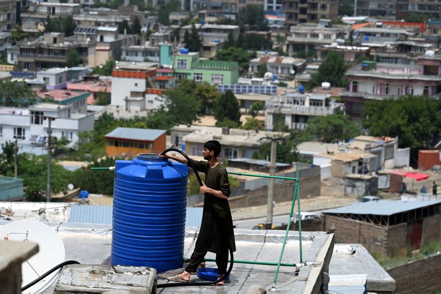 A man fills the water tank of his home in Kabul on July 13, 2021.