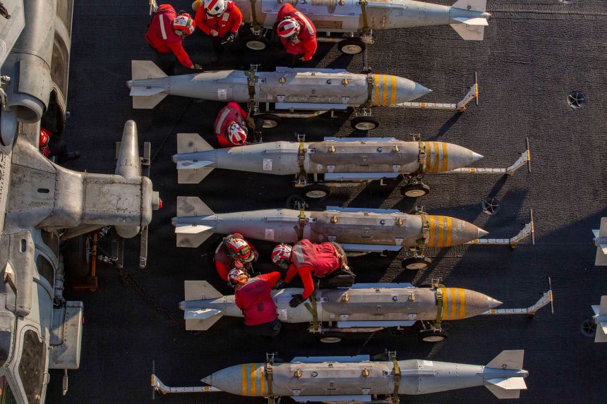 US sailors prepare ordnance on the flight deck of the USS Abraham Lincoln in support of Operation Epic Fury on February 28.
