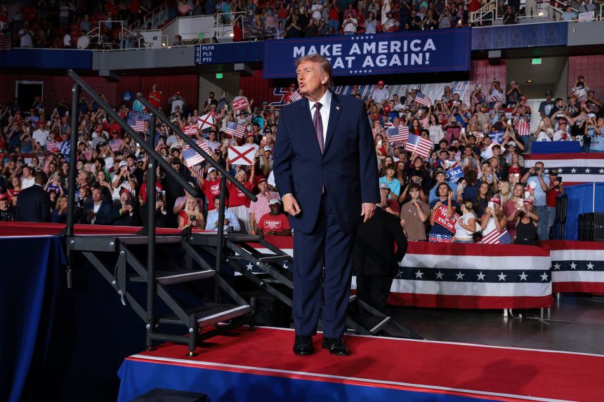 President Donald Trump walks off the stage after speaking at a campaign rally at the University of South Alabama in Mobile, Alabama, on October 2.