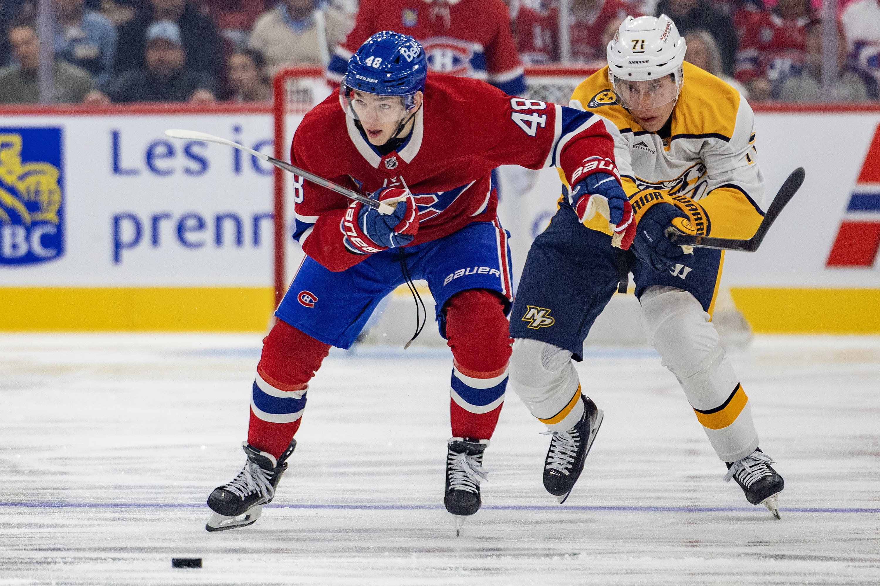 Canadiens defenceman Lane Hutson advances the puck while being pursued by Nashville Predators' Matthew Wood during first period in Montreal on Oct. 8.