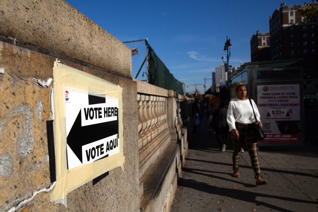 Pedestrians stroll on Grand Concourse past an early voting site inside Bronx Supreme Court.
