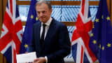FILE PHOTO: EU Council President Donald Tusk holds British Prime Minister Theresa May's Brexit letter which was delivered by Britain's permanent representative to the European Union Tim Barrow (not pictured) that gives notice of the UK's intention to leave the bloc under Article 50 of the EU's Lisbon Treaty in Brussels, Belgium, March 29, 2017. 