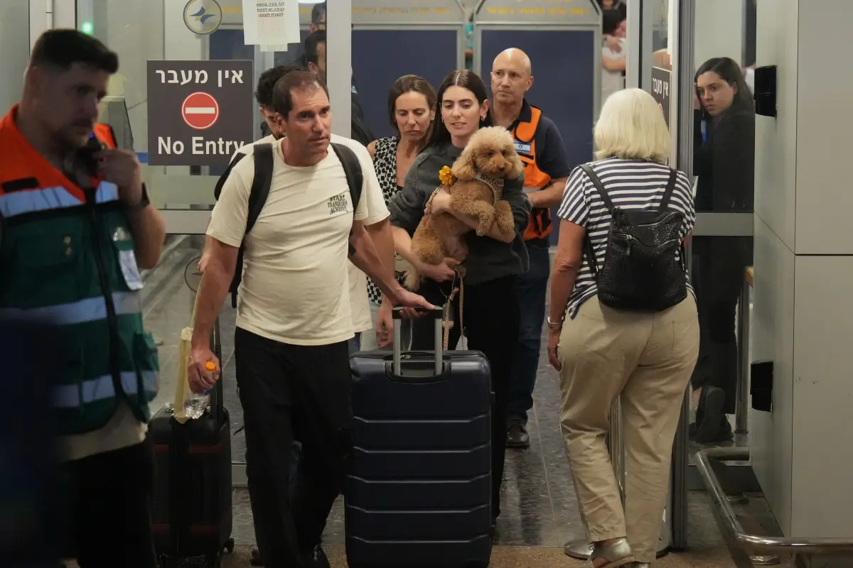 Passengers who experienced an emergency landing in Saudi Arabia during a flydubai flight arrive at Ben Gurion International Airport, near Tel Aviv, Israel, Wednesday.