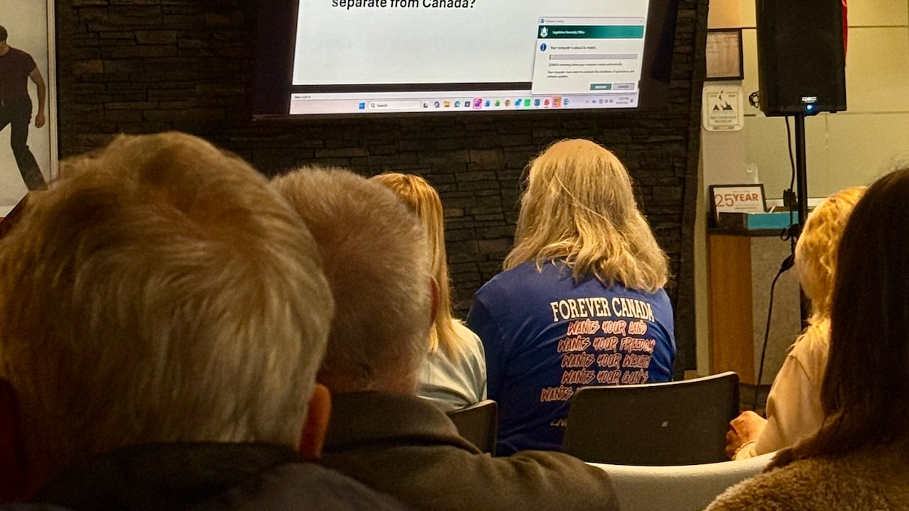 A woman stares at a screen.