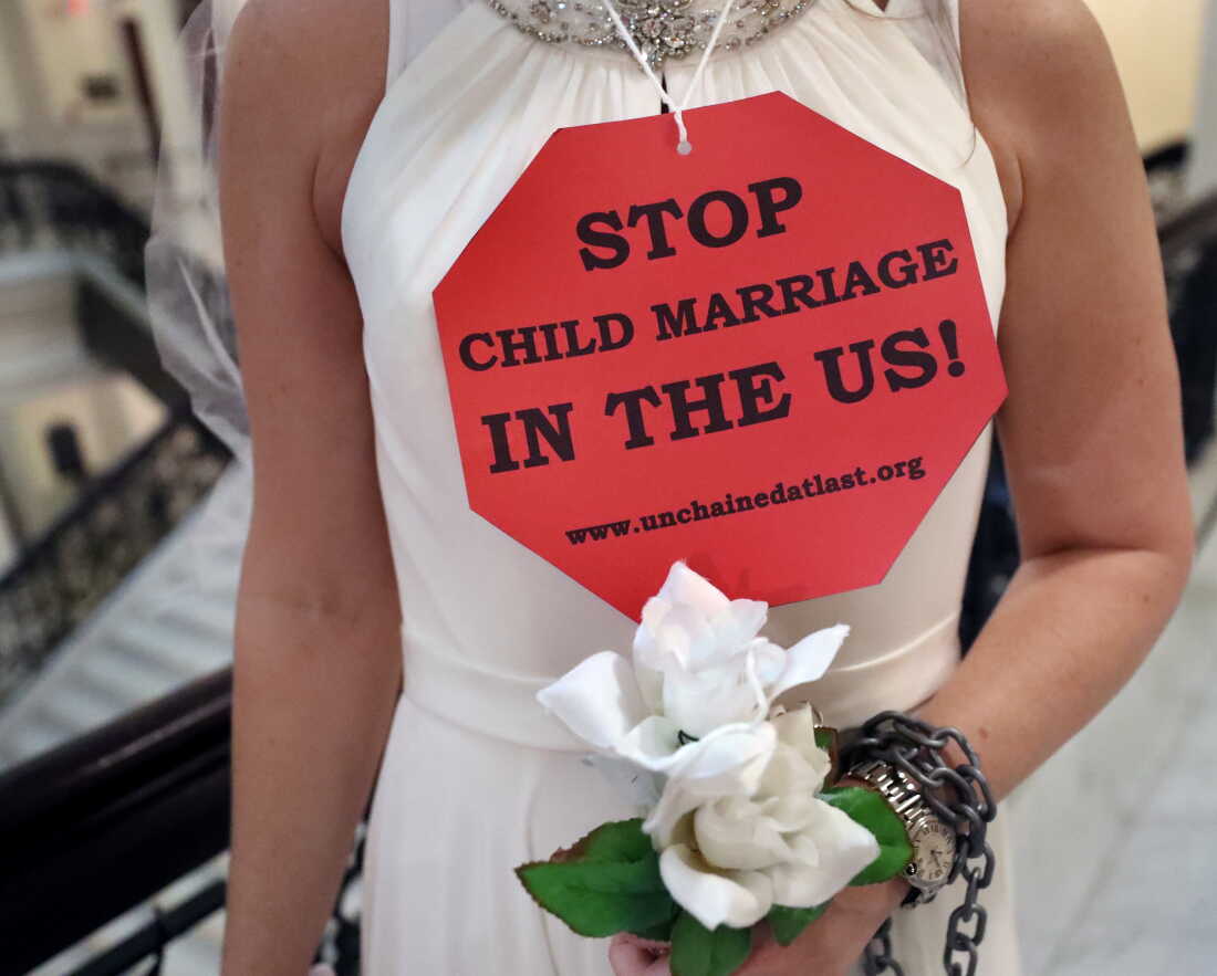 BOSTON, MA - MARCH 27: A demonstrator wearing a bridal gown takes part in a protest urging legislators to end Massachusetts child marriage at the Massachusetts State House in Boston on March 27, 2019. A committee hearing took place Tuesday about a Senate bill that would prevent minors from getting married in Massachusetts. Currently, some under 18 can marry with the consent of at least one parent.