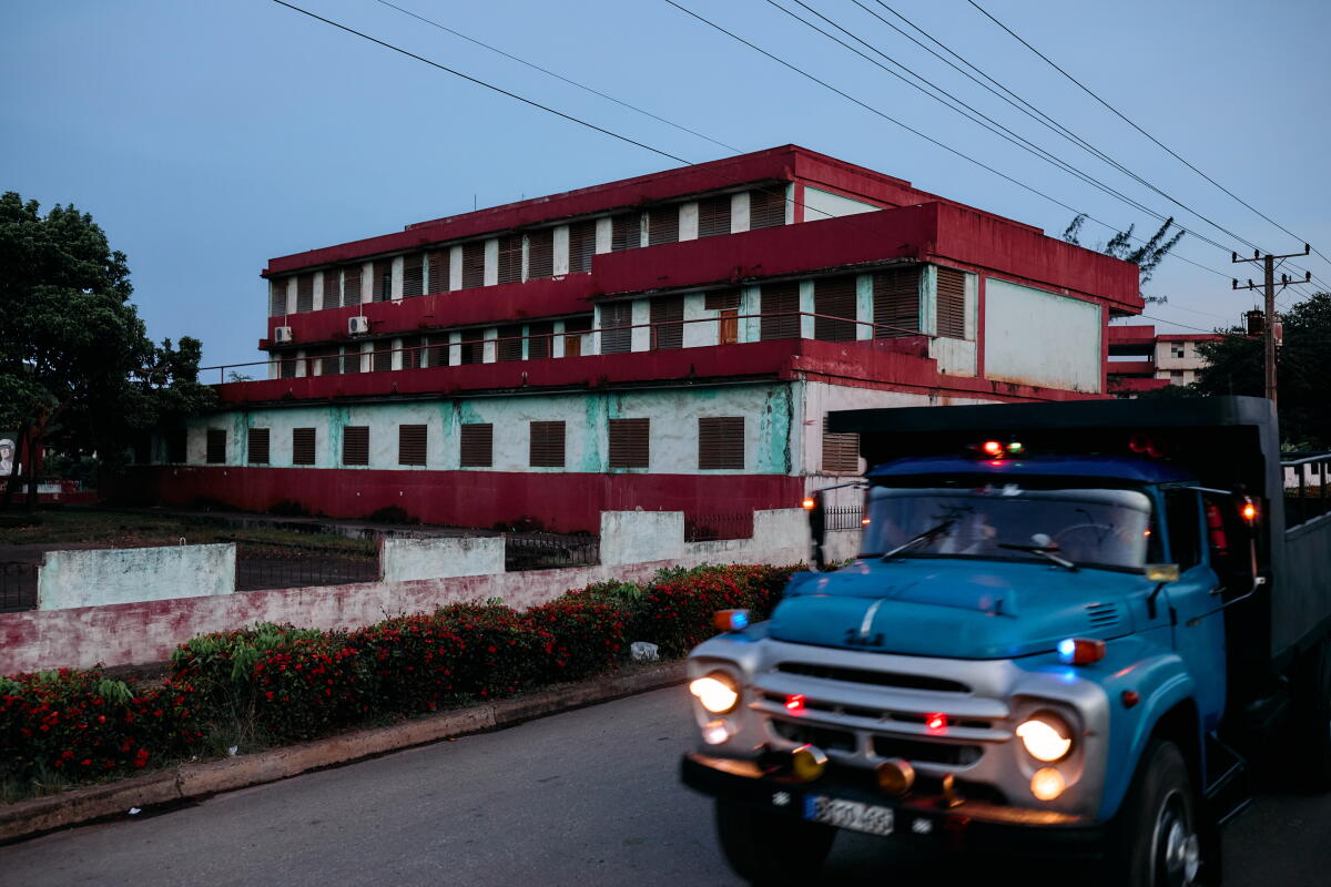 A truck passes this Soviet-style building in Moa, an industrial city on Cuba's northeast coast.