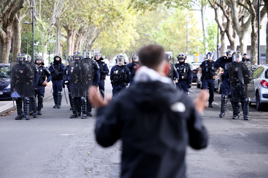 French police face off with a student outside Lycée Paul Éluard on Thursday.