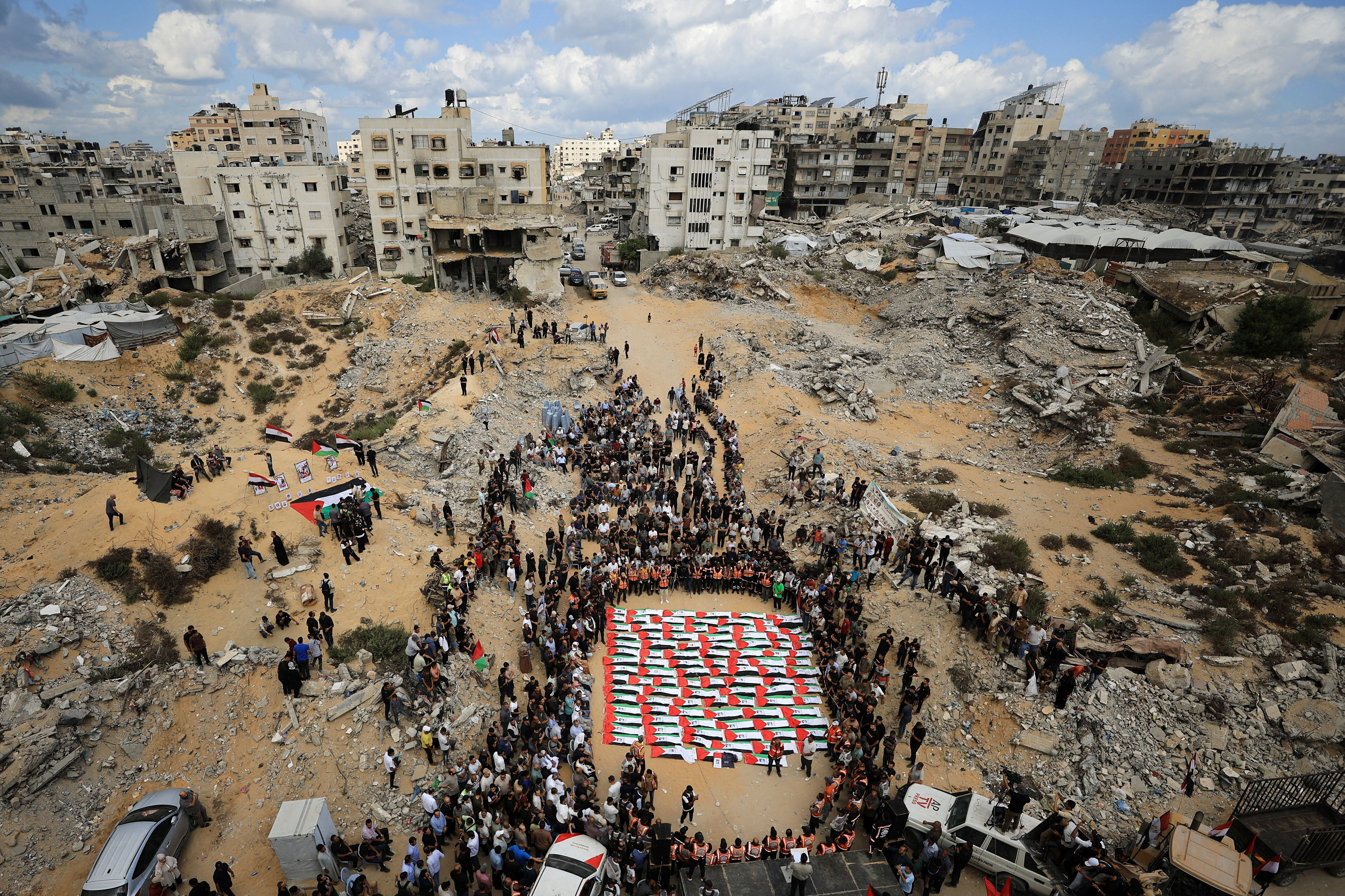 Mourners attend a mass funeral for Palestinians whose bodies were recovered from the rubble of a residential building hit in an Israeli strike in October 2023 in Gaza City on October 1, 2026. (REUTERS)
