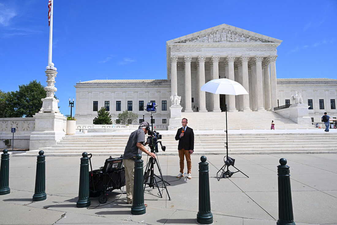 Broadcast journalists work in front of the U.S. Supreme Court in Washington, D.C., on Sept. 15. The new term begins on Monday.