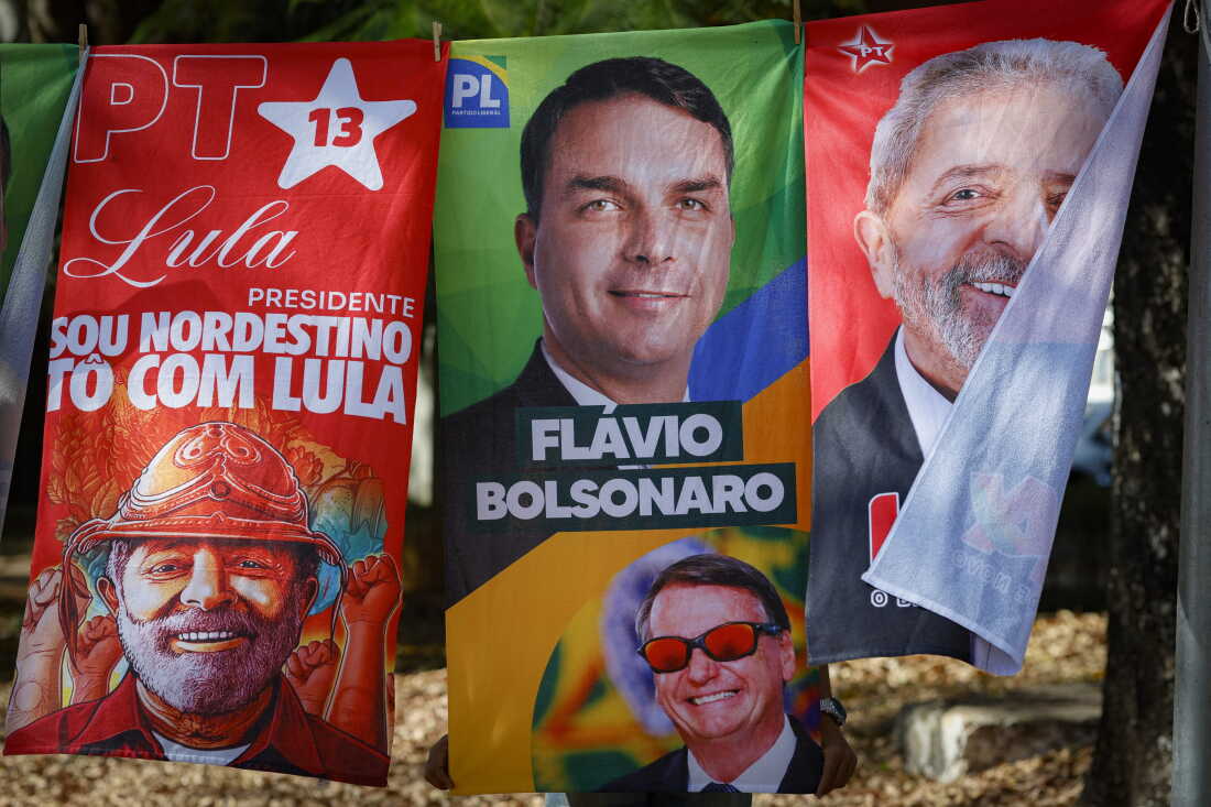 Towels and caps for sale depicting Brazilian presidential candidates Luiz Inacio Lula da Silva and Flavio Bolsonaro are seen in a residential area of Brasília on September 11, 2026. Brazil will hold a presidential elections on October 4, 2026.