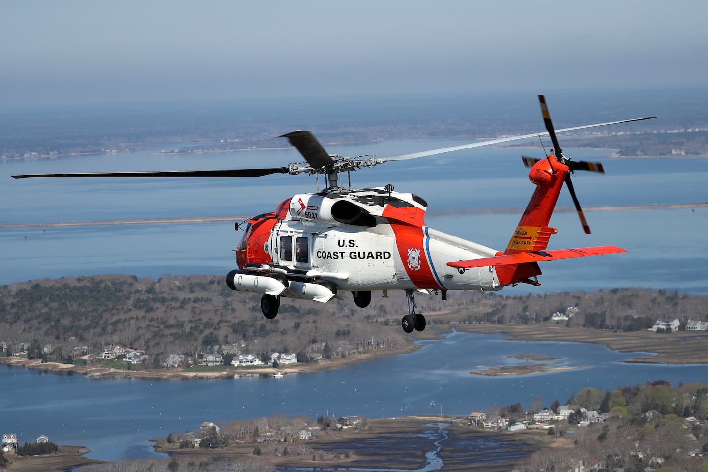 A US Coast Guard helicopter shown flying over Cape Cod in a file photo, as the Coast Guard searches for a missing air ambulance.