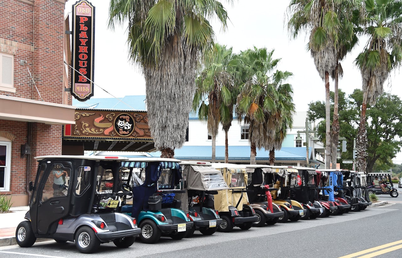 Golf carts line the street in The Villages retirement community outside of Orlando, Fla. Florida permanent residents could see a dramatic decrease in property taxes if a ballot measure passes.