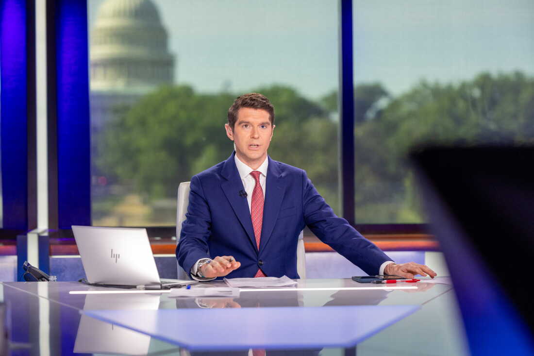 Wearing a blue suit, Benjamin Hall sits behind a news anchor's desk as he hosts "Fox News Sunday" on May 12, 2024.
