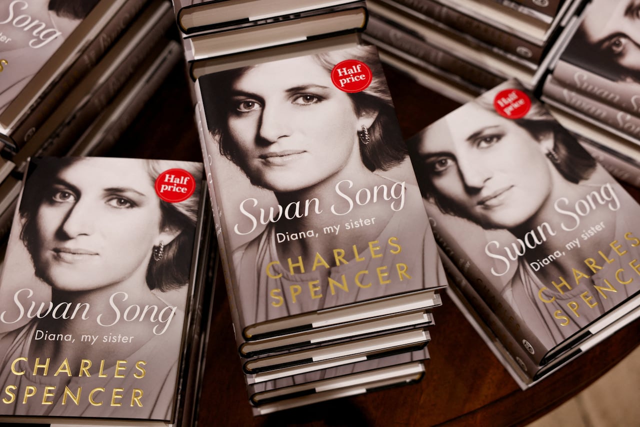Books with the title Swan Song: Diana, my sister sit stacked on a table.