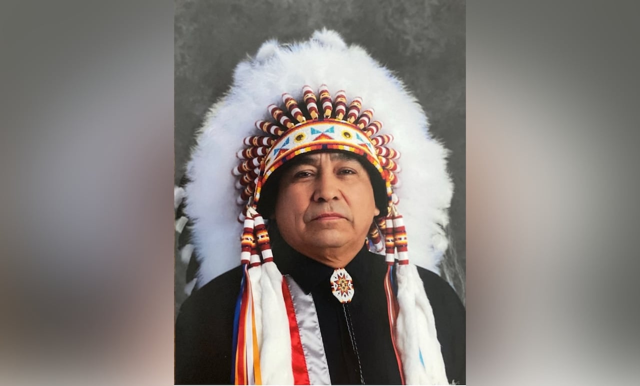 Chief Nelson Genaille wearing a traditional headdress.