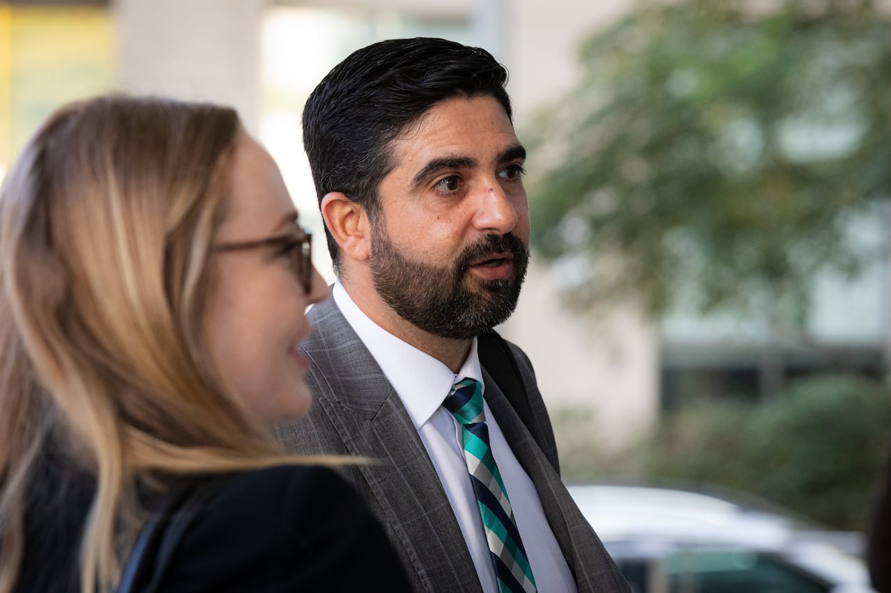 Photo shows two prosecutors in the Nicholas Cartel case conversing outside court after the first day of trial.