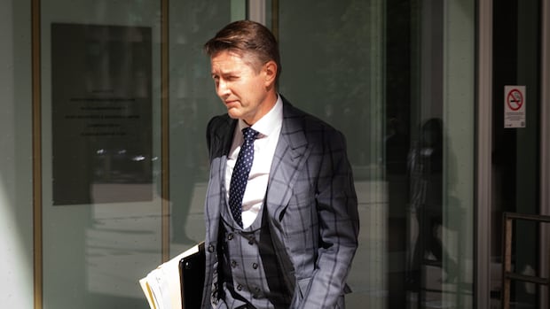 High-flying lawyer goes on trial for writing bad cheque allegedly to cover for collapsing firm
