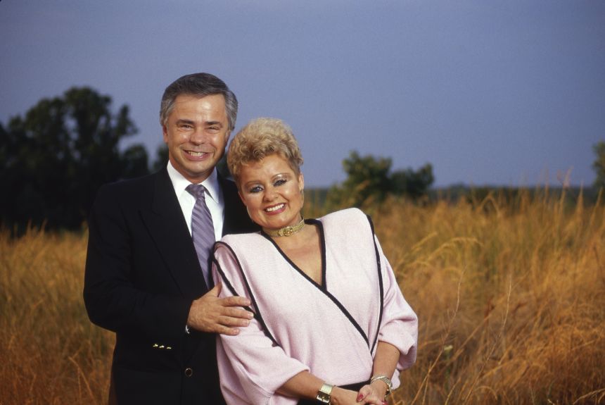 Jim and Tammy Faye Bakker on a hill overlooking their megachurch complex,in Fort Mill, South Carolina, in August 1987.