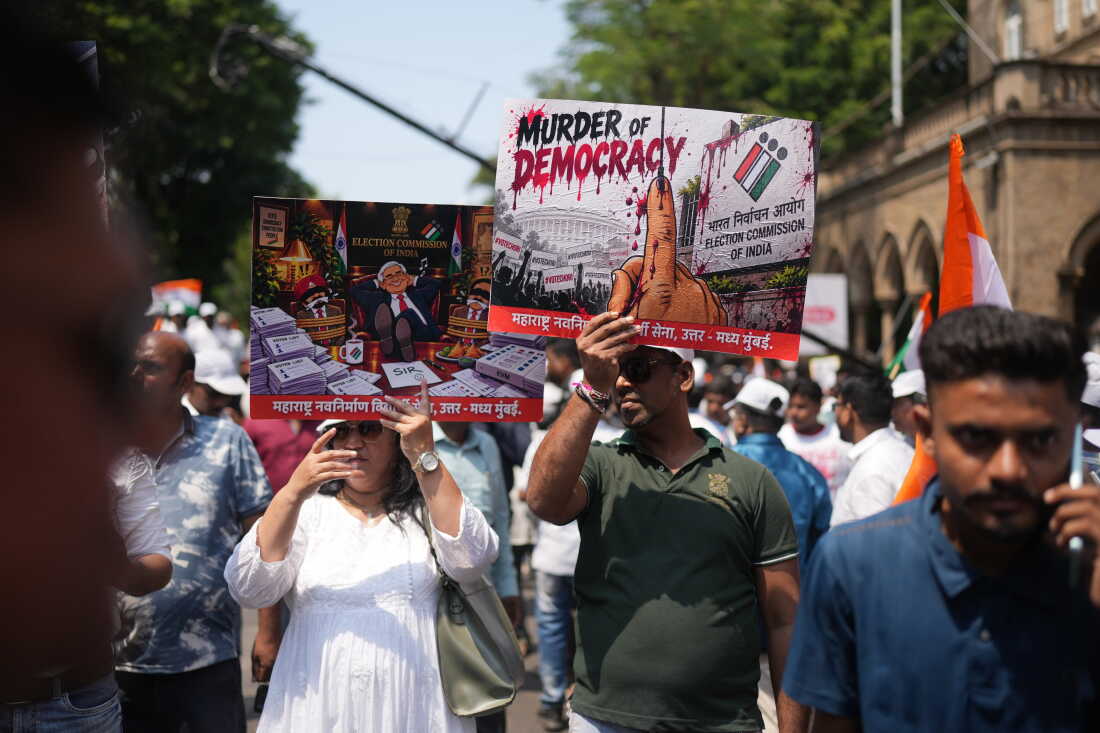 Protesters hold placards during a protest organized by Shiv Sena (UBT) and the Maharashtra Navnirman Sena, demanding the resignation of Chief Election Commissioner Gyanesh Kumar and the suspension of the Special Intensive Revision (SIR) of electoral rolls, in Mumbai, India, Sunday, Oct. 4, 2026.