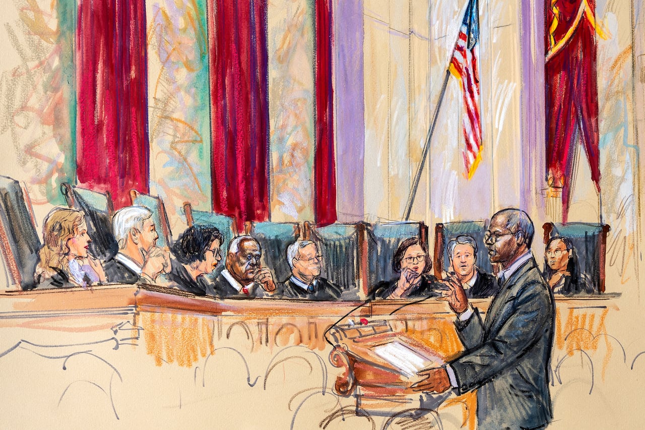 Sketch of a man in a suit at a podium addressing a semicircle of judges behind a bench with red curtains and the American flag in the background