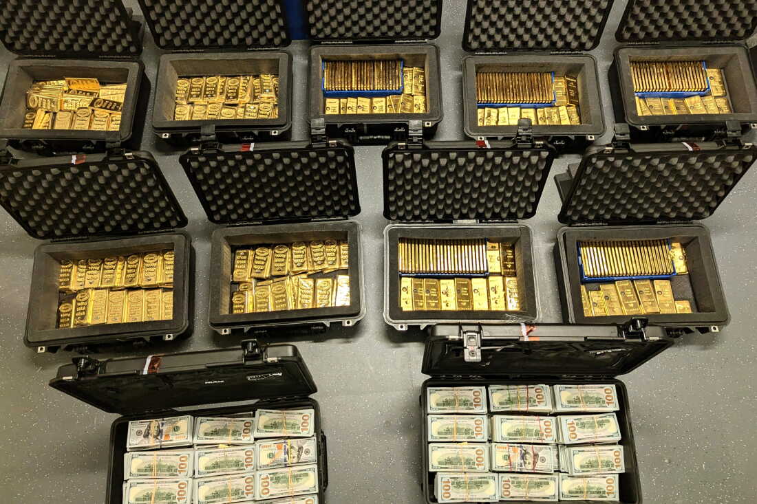 This image provided by U.S. Department of Justice, and contained in a court filing, shows gold bars and cash that was seized from a David J. Rush's home, during a search on May 19, 2026, in Ashburn, Va.