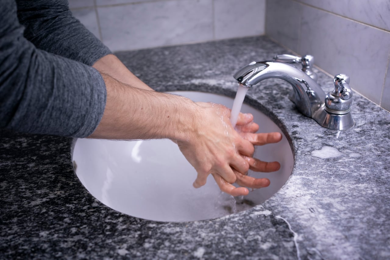 Man washing hands in sink