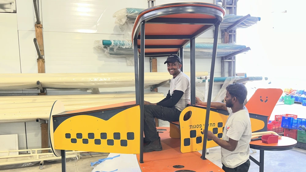 Sri Lankan workers assemble an airplane-themed play structure at the Psagot Playgrounds factory in Psagot, in the Binyamin region of Samaria, Oct. 5, 2026. Photo by Josh Hasten.