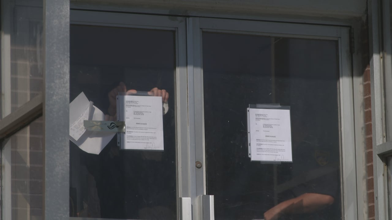 Two notices on either side of a double door.